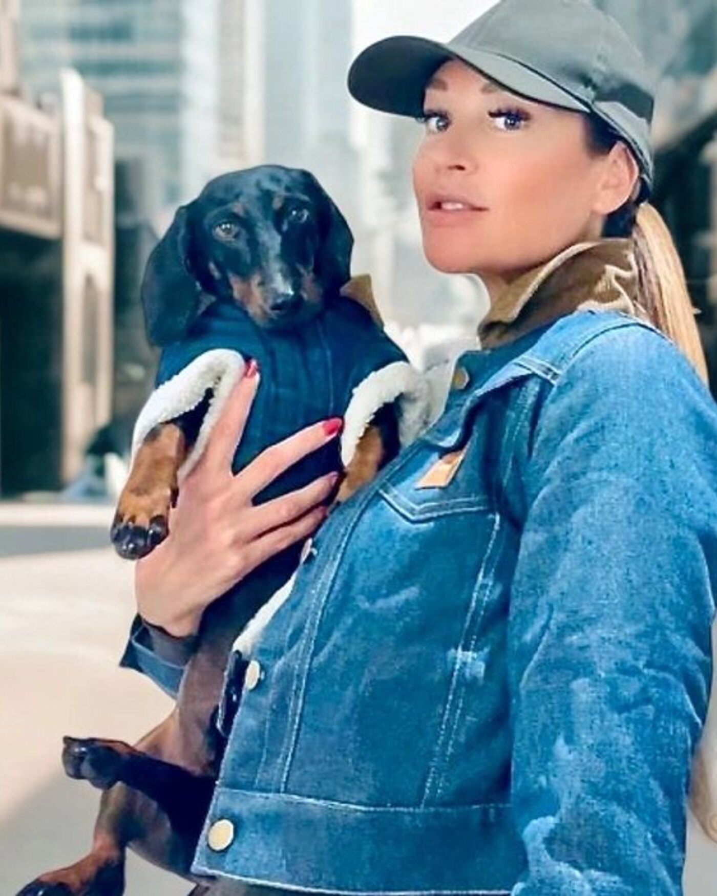 Natascha, founder of Cooper&Cosmo Fashion, holding her dachshund in matching denim — New York City